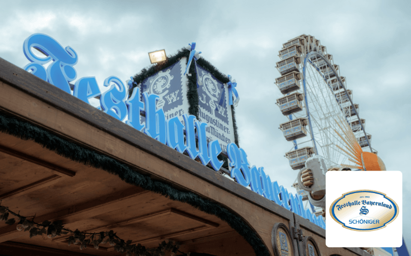 Festhalle Bayernland Schöniger auf einem Volksfest mit Riesenrad im Hintergrund